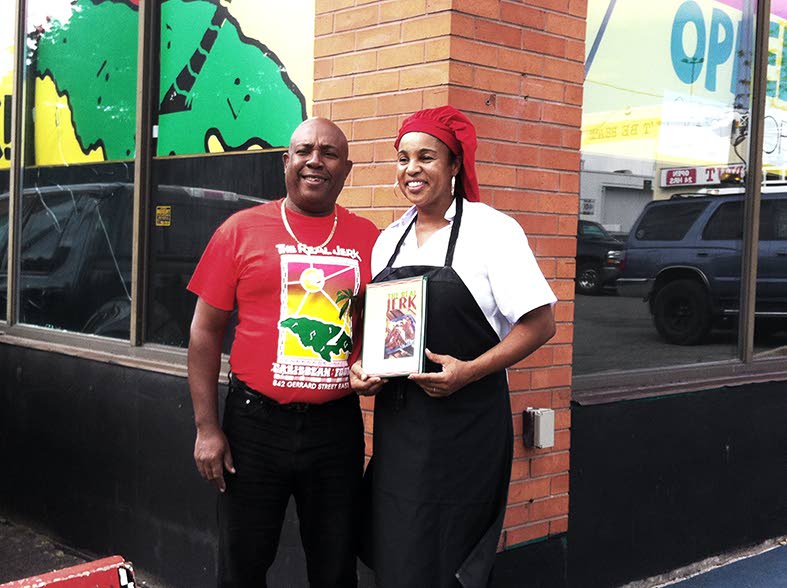 Ed and Lily Pottinger with their book outside The Real Jerk restaurant in 2013.