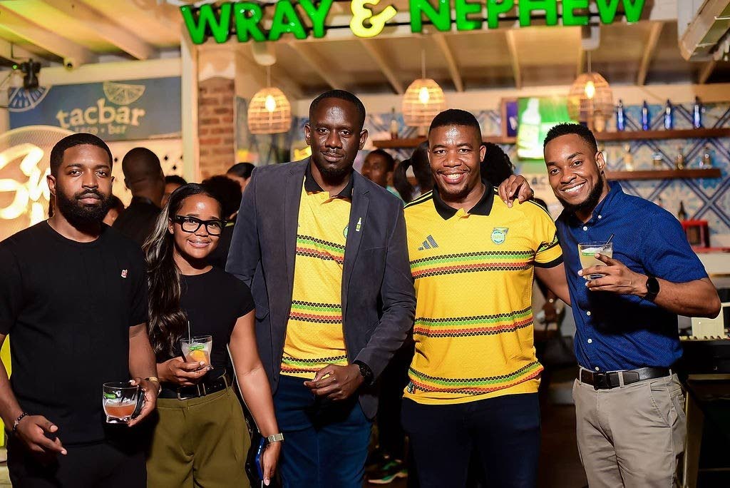 Miguel Coley (second right), Reggae Boyz assistant coach, poses with members of the J. Wray & Nephew Ltd team (from left) Campari Brand Manager Jerome Walters; Brand Activator Shanice Mitchell; Event Execution Specialist Tesfaye Brown; Marketing Manager Pa