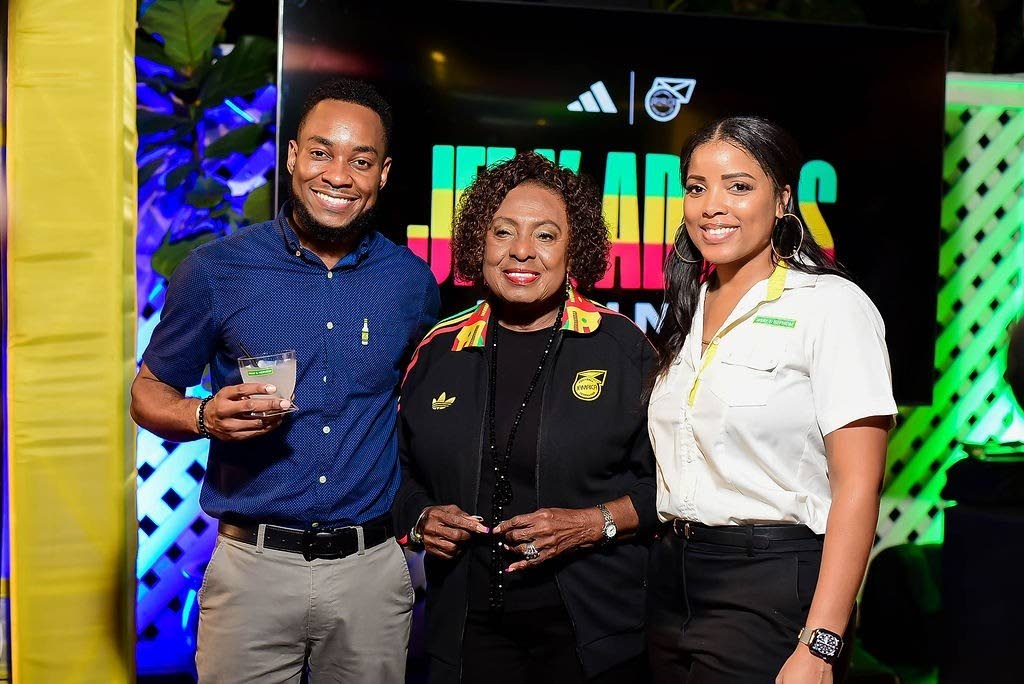 Pavel Smith, marketing manager, J. Wray & Nephew Ltd., and his colleague, Simone Foster (right), brand experience manager, share a moment with Olivia Grange (centre), minister of culture, gender, entertainment and sport.