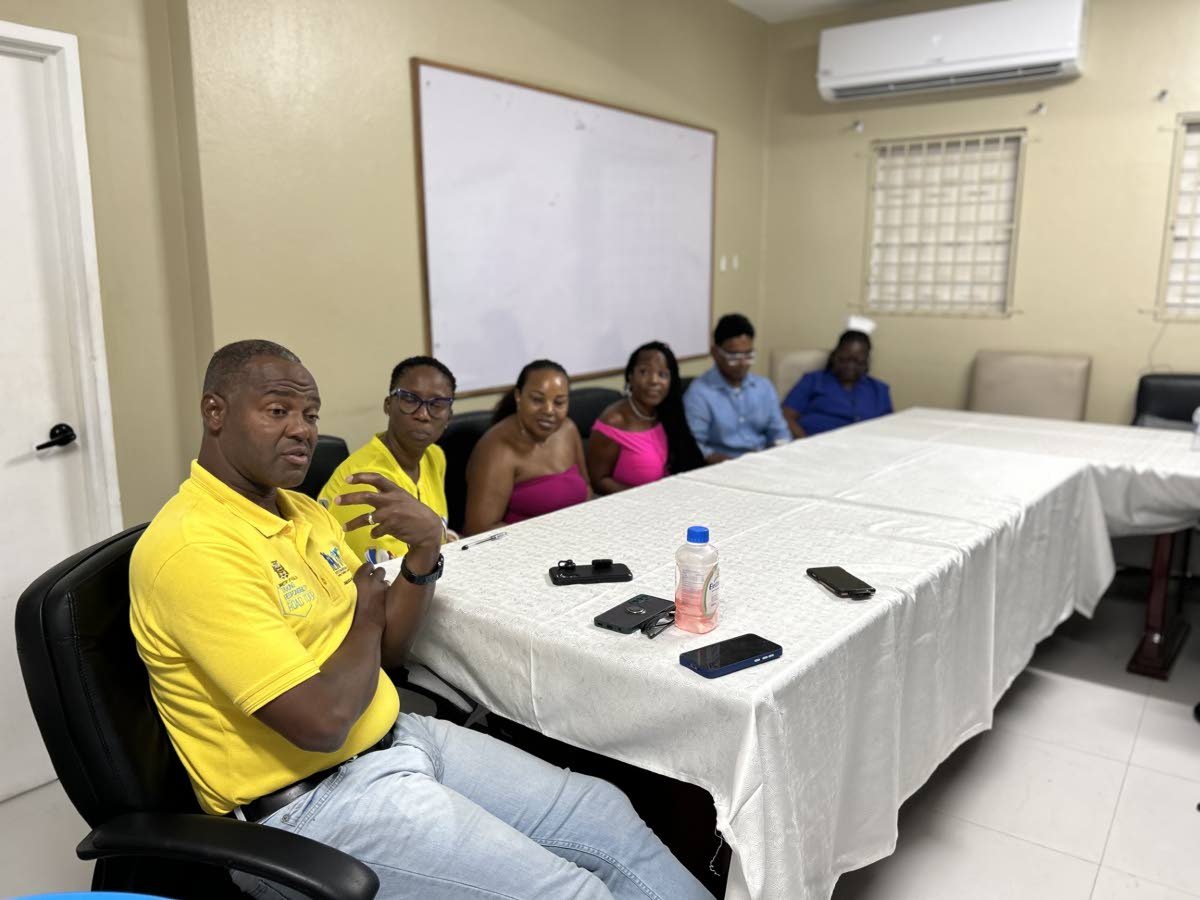 Chief Executive Officer Roan Grant engages with stakeholders and members of the Support Your Girlfriends Foundation in a discussion during the donation ceremony at Savanna-la-Mar Public General Hospital.