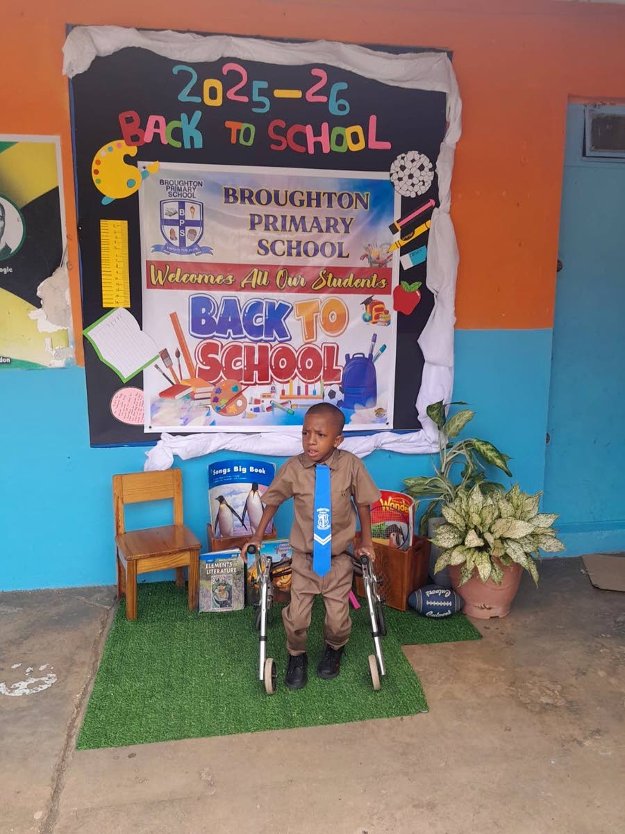 Keneil Parkinson moves around the school compound with the aid of his walker.