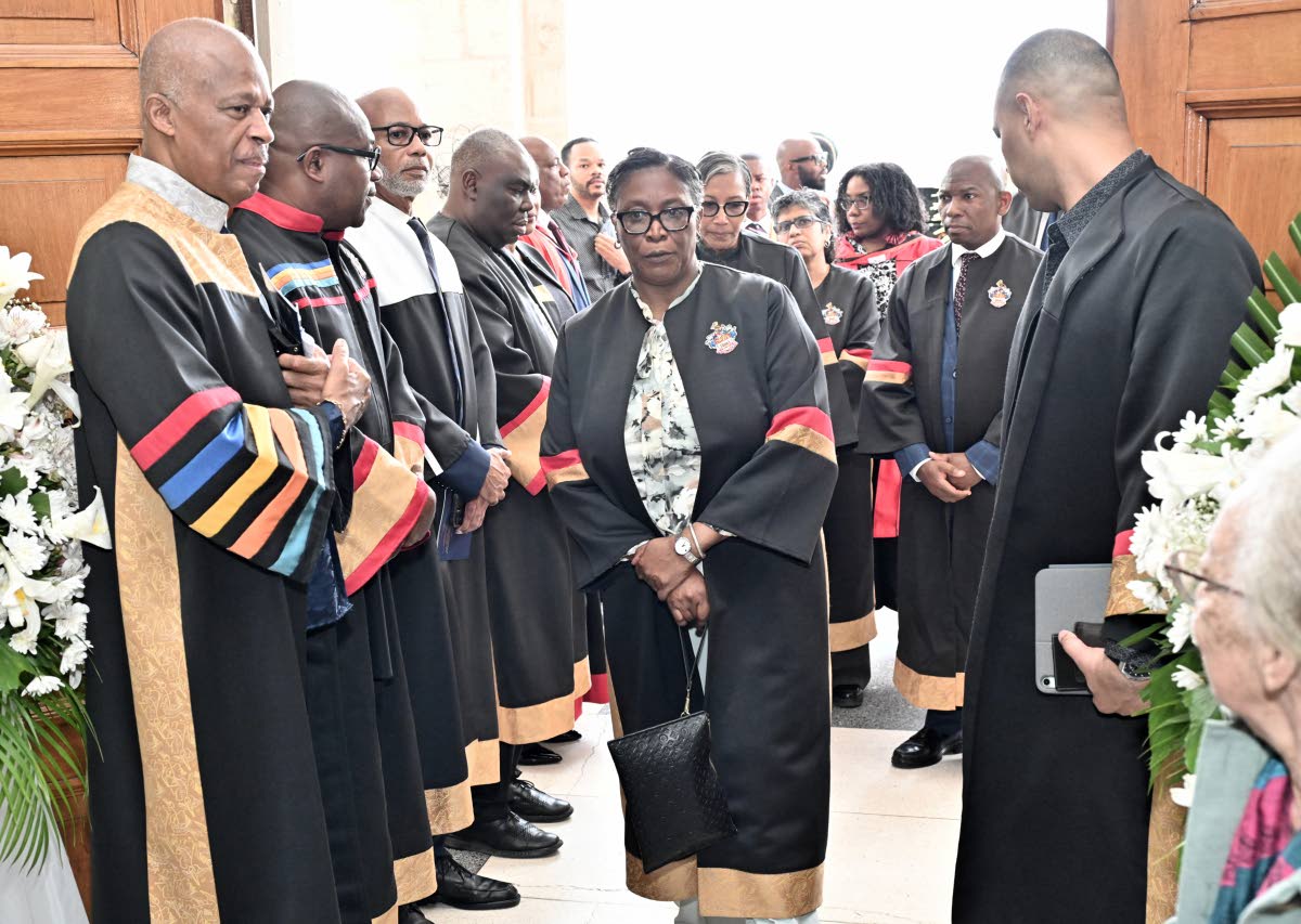 Professor Sir Hilary Beckles (left), vice-chancellor of The UWI, Professor Densil A. Williams (second left), pro-vice chancellor and campus principal, and other members of The UWI enter the University Chapel for the funeral.  