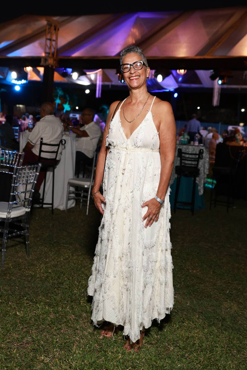 Kathy Francis McClure is all smiles, rocking a white maxi for the occasion. 