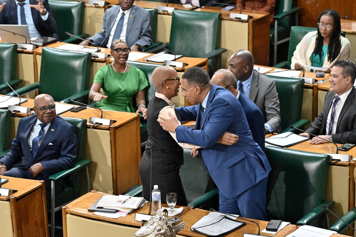 Prime Minister Dr Andrew Holness embraces Fayval Williams, minister of finance and the public service, after her closing of the 2026-2027 Budget Debate in the House of Representatives yesterday.