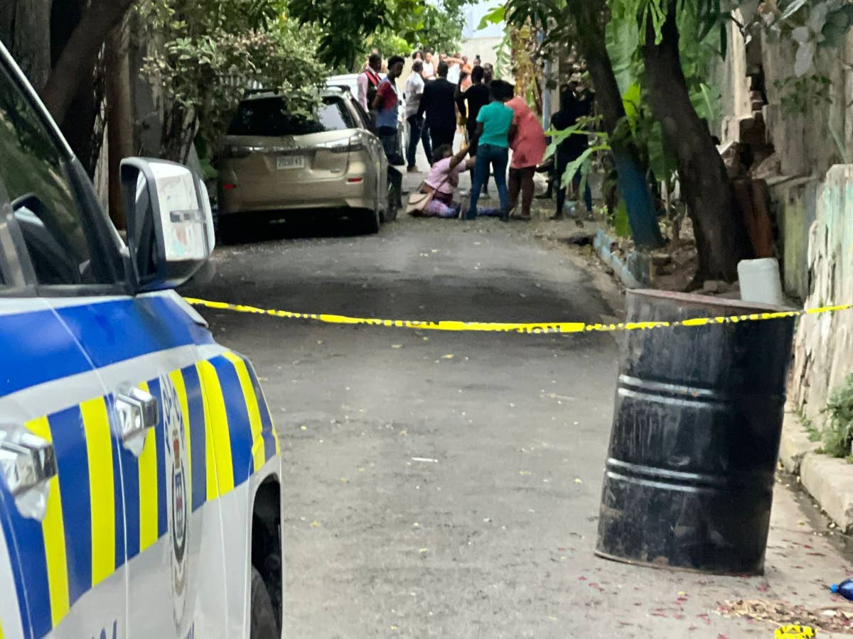 Supporters try to assist Henry’s mother-in-law after she collapsed to the ground in grief in the nearby Luke Lane area in Kingston. 