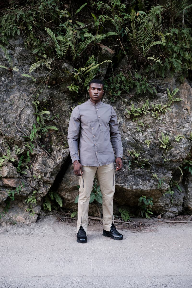 This smoke gun grey cotton tailored long-sleeve shirt, worn by model Rhyeme Wright, is defined by a distressed seam line. 