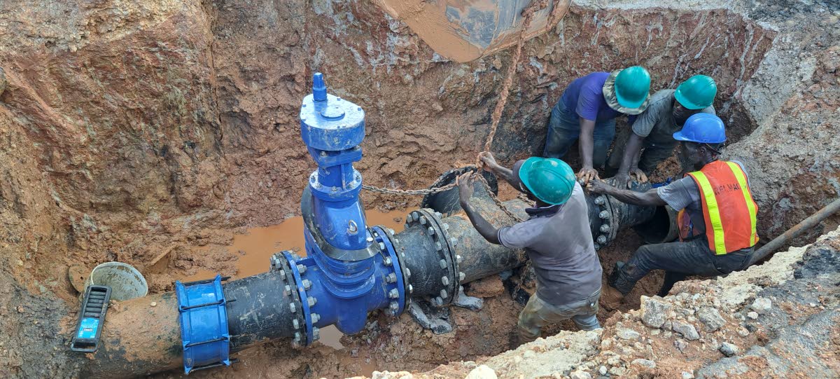 NWC workmen installing 16-inch-diameter ductile iron pipes from the Jericho main to the Linstead-Ewarton main road in St Catherine.