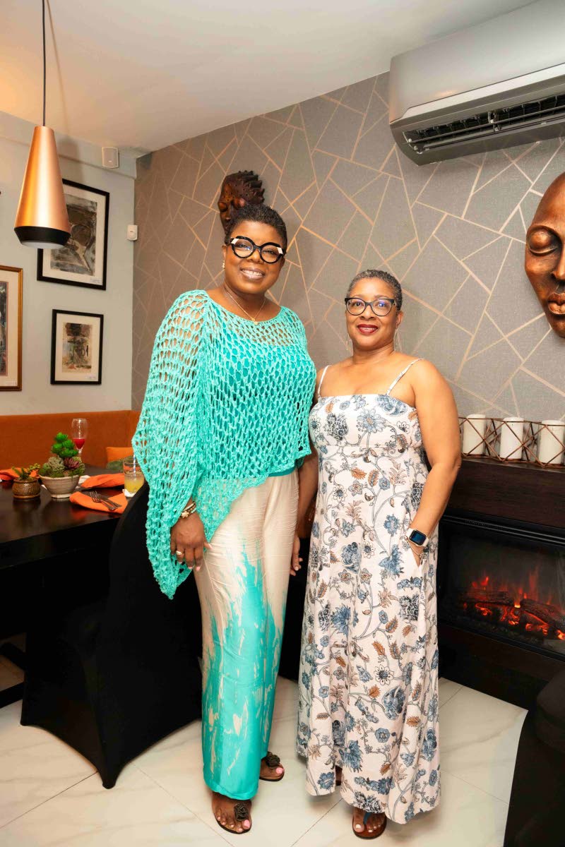 Georgia Morrison (left), of CUNA Caribbean Insurance, pairs up with her gal pal, Sheryll Brown, of the Jamaica Public Service Company, for a quick photo op.