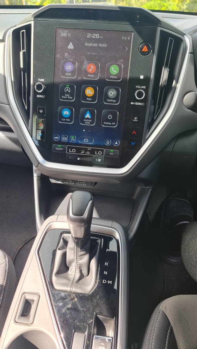 The leather-wrapped gear selector is positioned within a straightforward, ergonomic housing, flanked by the activation switches for the dual-function X-MODE system.