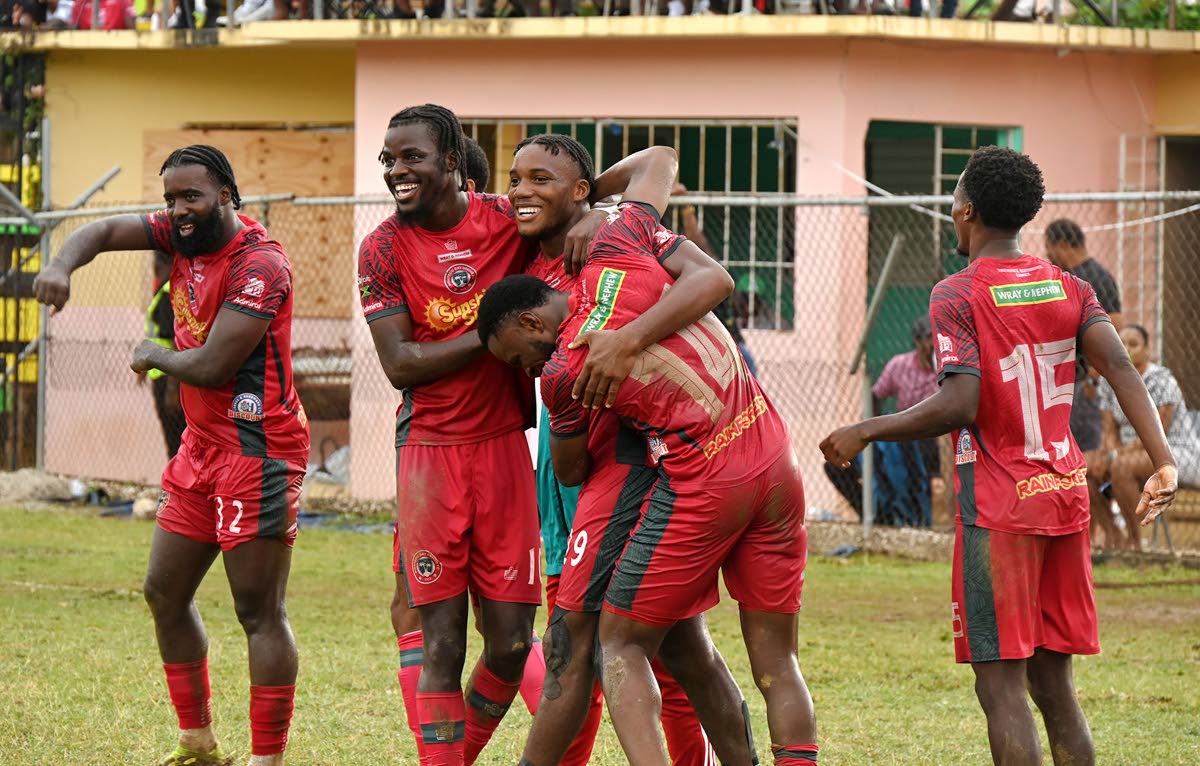 
Richardo Ramsey (centre) celebrates with Montego Bay United teammates after scoring his second goal against Dunbeholden FC during their Jamaica Premier League football game at Jarrett Park in Montego Bay on March 18.
