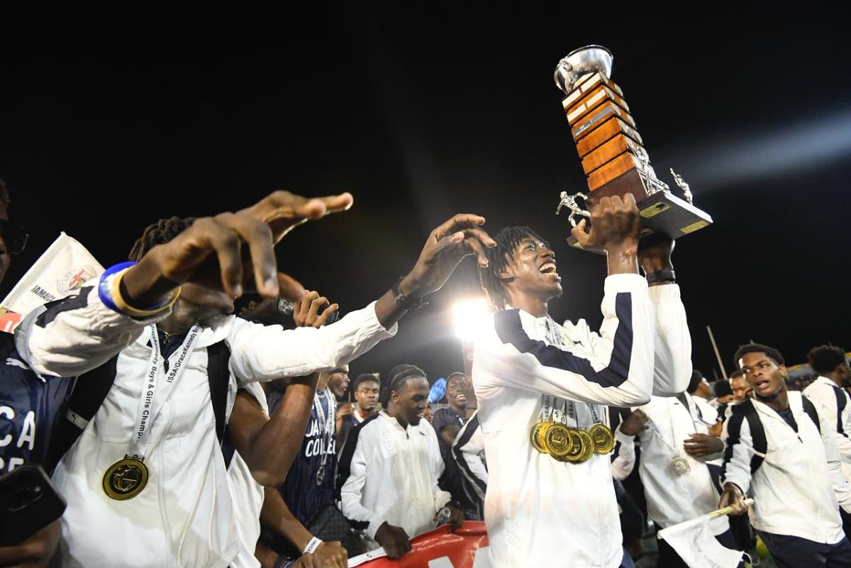 Jamaica College Athletes celebrate winning the ISSA/GraceKennedy Boys and Girls’ Athletics Championships title inside the National Stadium yesterday.