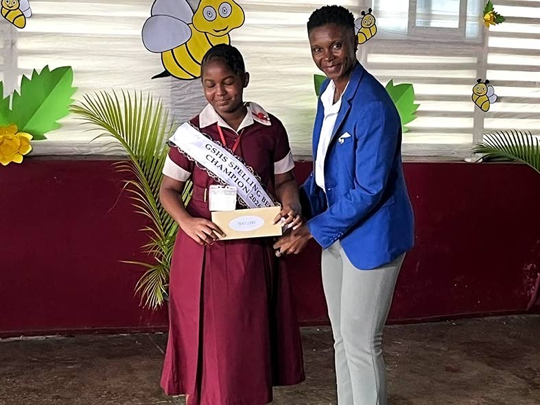 Winner Tahirah Lyn receives a cash prize from Spell Mistress Tanisha Bent.