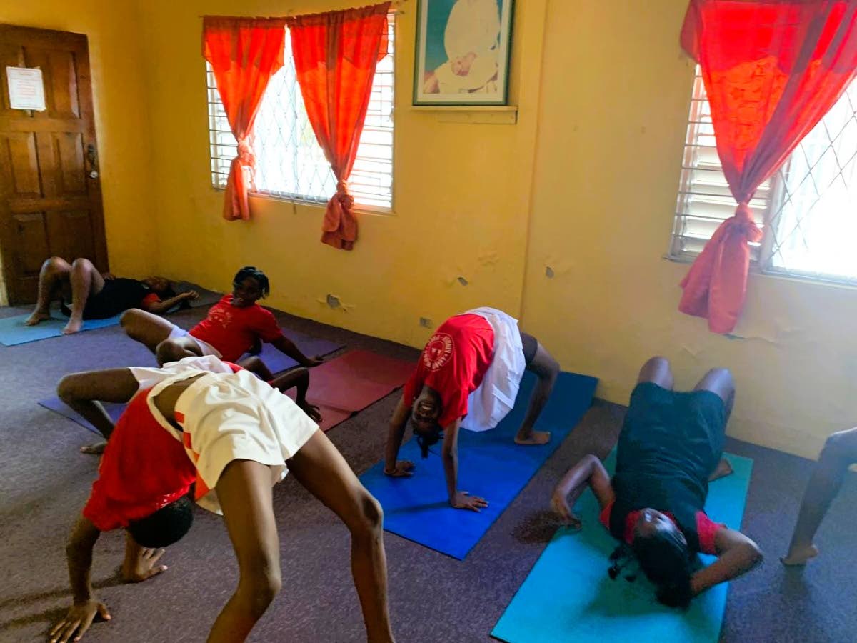 Children from Ananda Marga Schools practise yoga poses.