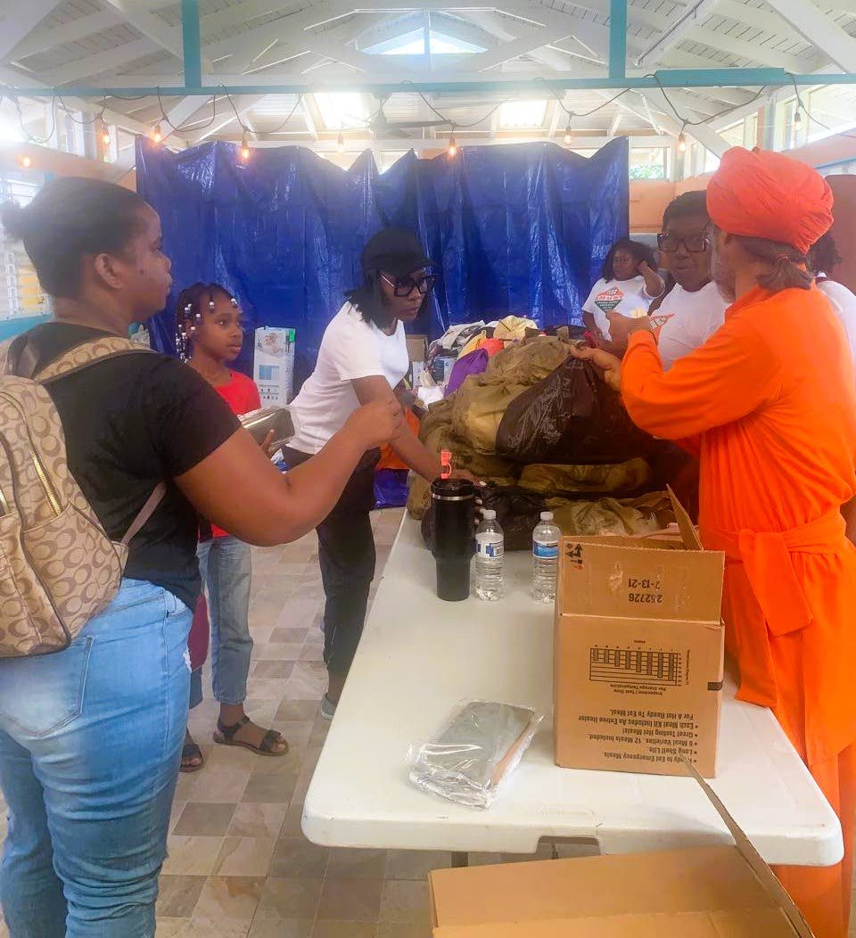 Acharya Gitisudhananda Avadhuta distributes relief supplies to families affected by Hurricane Melissa.