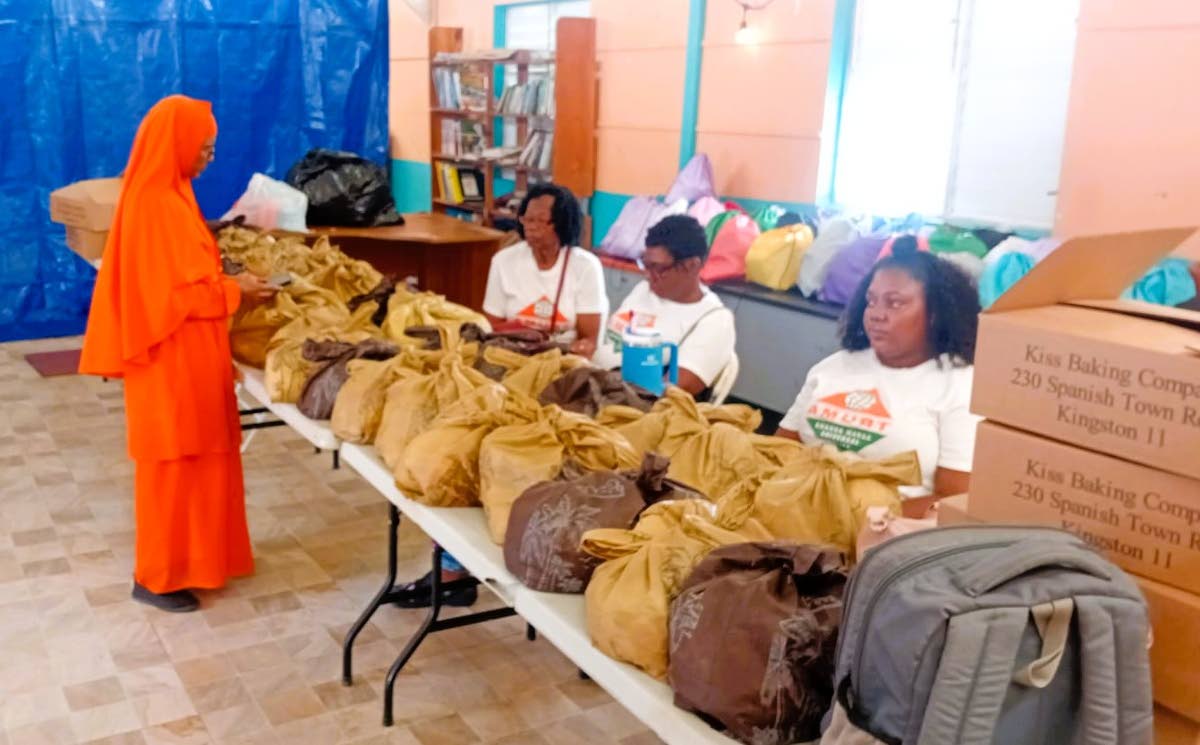Didi Ananda Devaprana Avadhuta addresses volunteers as they pack relief materials for distribution.