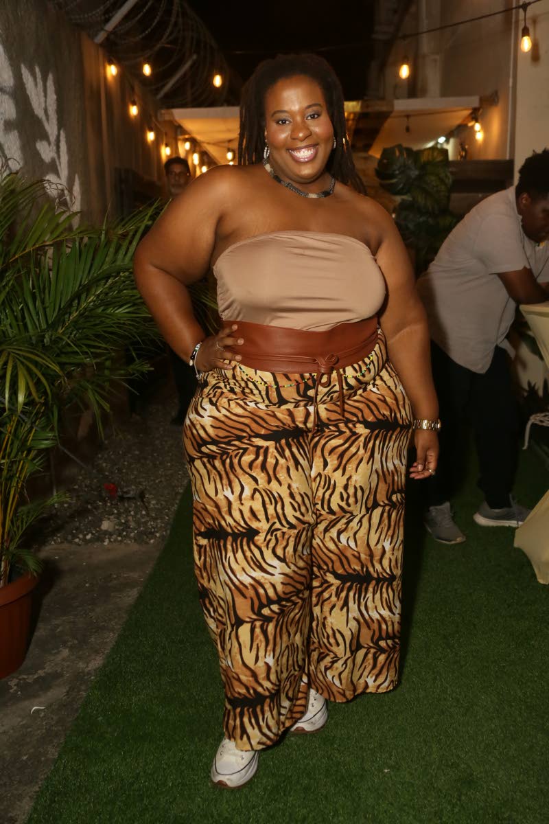 Singer Courtni injects bold energy with statement animal-print trousers.