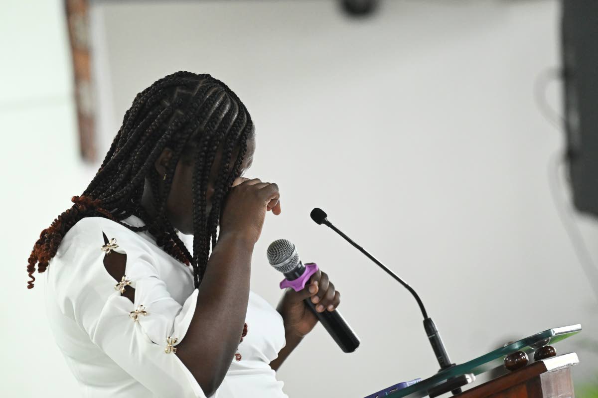 Kiero Pinnock's cousin, Karrena Pinnock, is overcome with emotion as she gives the remembrance during his funeral at the Regent Seventh-day Adventist Church in Kingston yesterday.
