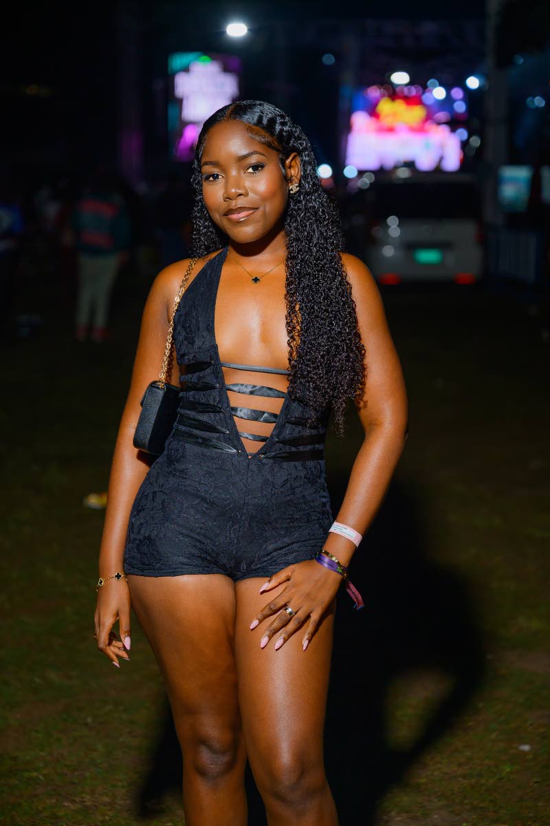 Accountant Britania Banton stuns in a black plunging neckline romper.