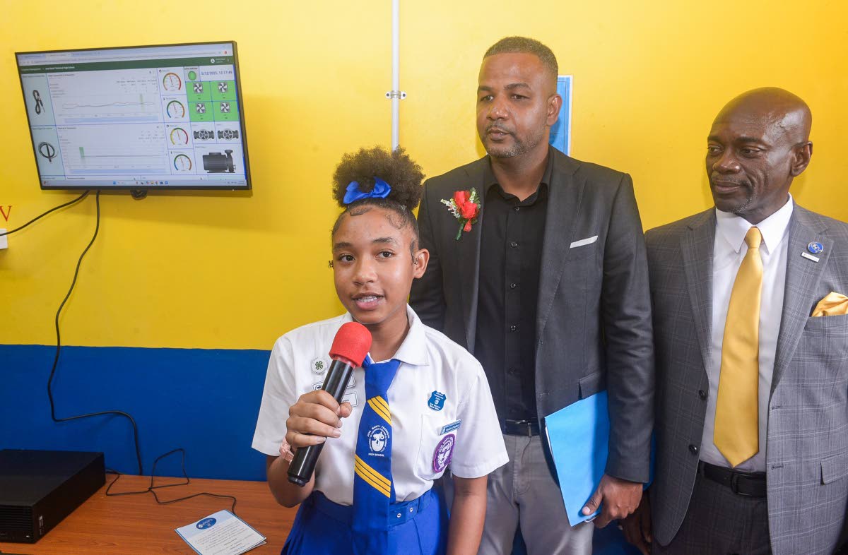 Student at José Martí Technical High School in St Catherine, Teandra Williams (left), explains features of the state-of-the-art smart greenhouse, gifted to the school by the Ministry of Education, Skills, Youth and Information. Others pictured are Senior