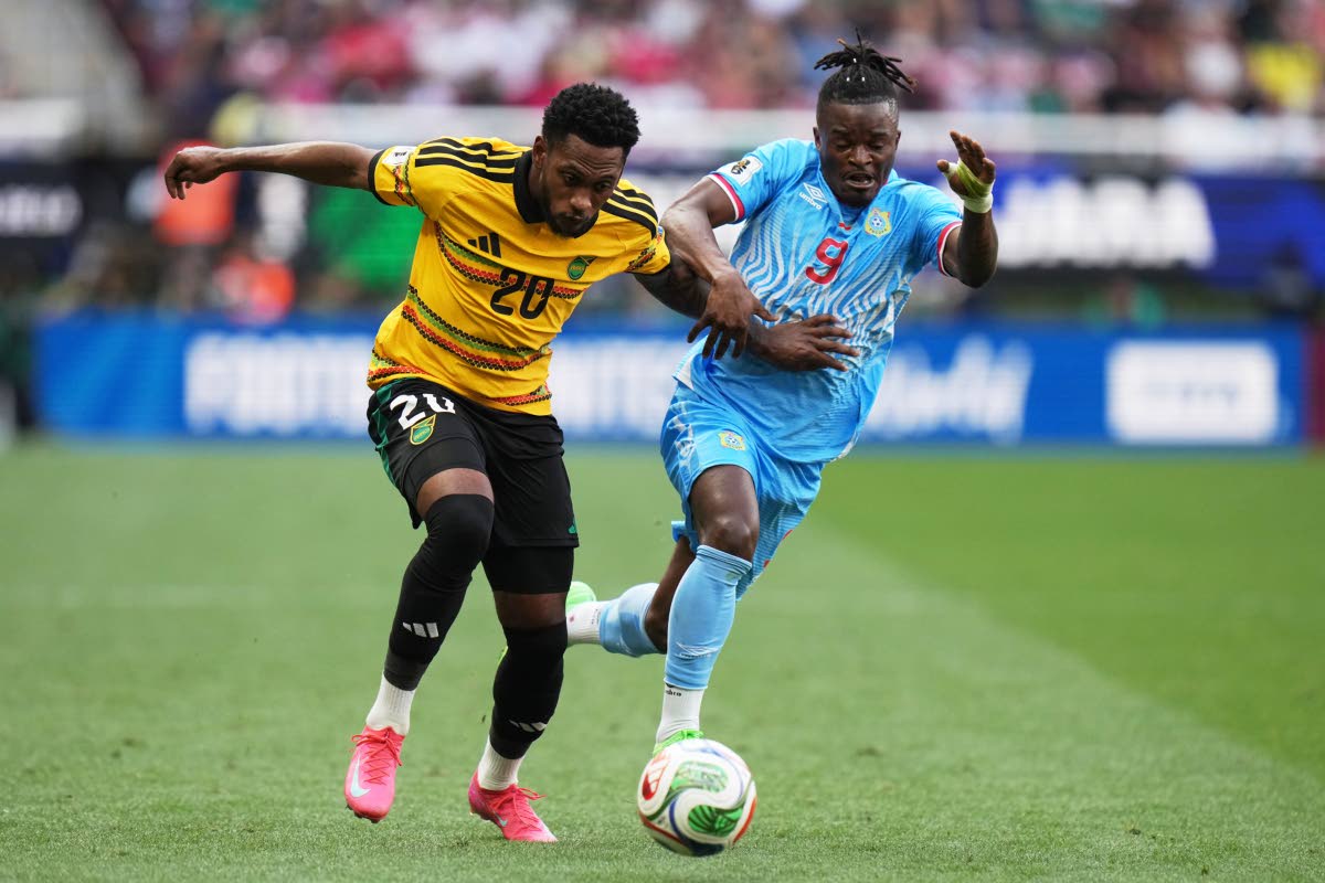 Jamaica’s Renaldo Cephas (left) and DR Congo’s Brian Cipenga vie for the ball during the Intercontinental World Cup Playoff final in Guadalajara, Mexico yesterday.