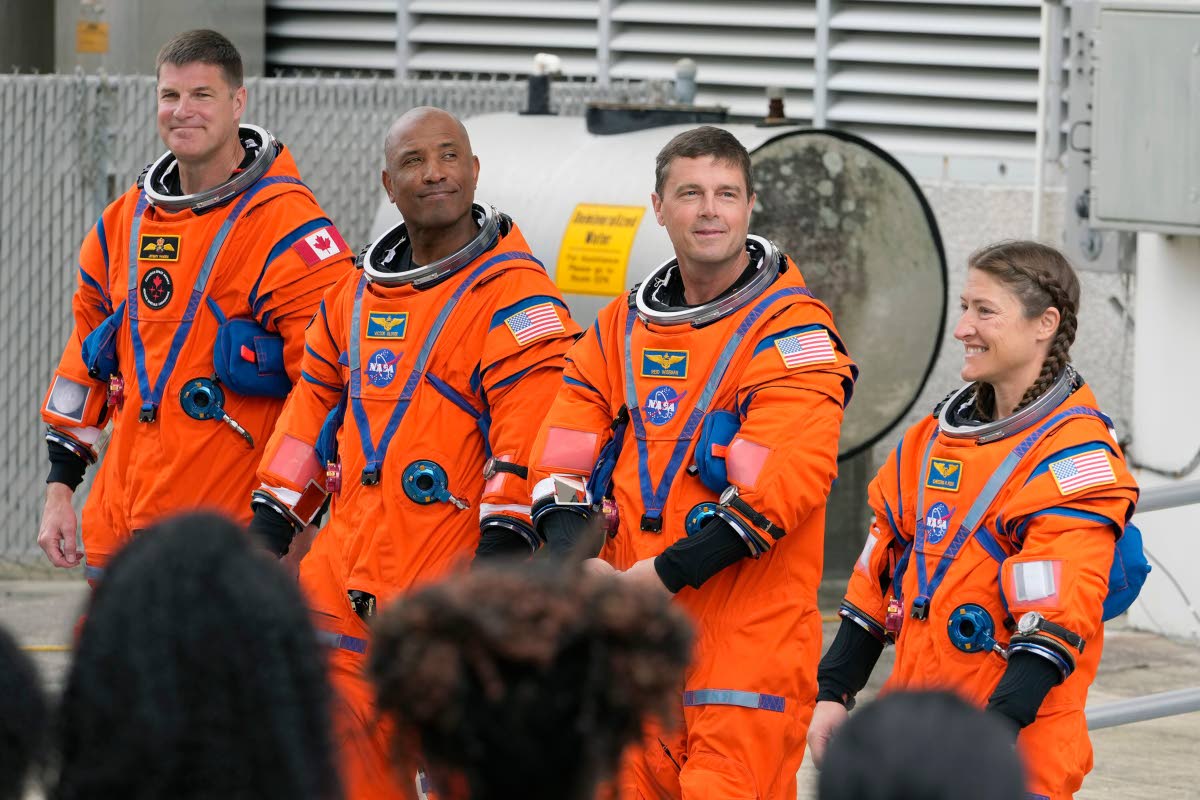 Astronauts, from left, Mission Specialist Jeremy Hansen, of Canada,, Pilot Victor Glover, Commander Reid Wiseman, and Mission Specialist Christina Koch pose for a photo after leaving the Operations and Checkout Building for a trip to Launch Pad 39-B and a 