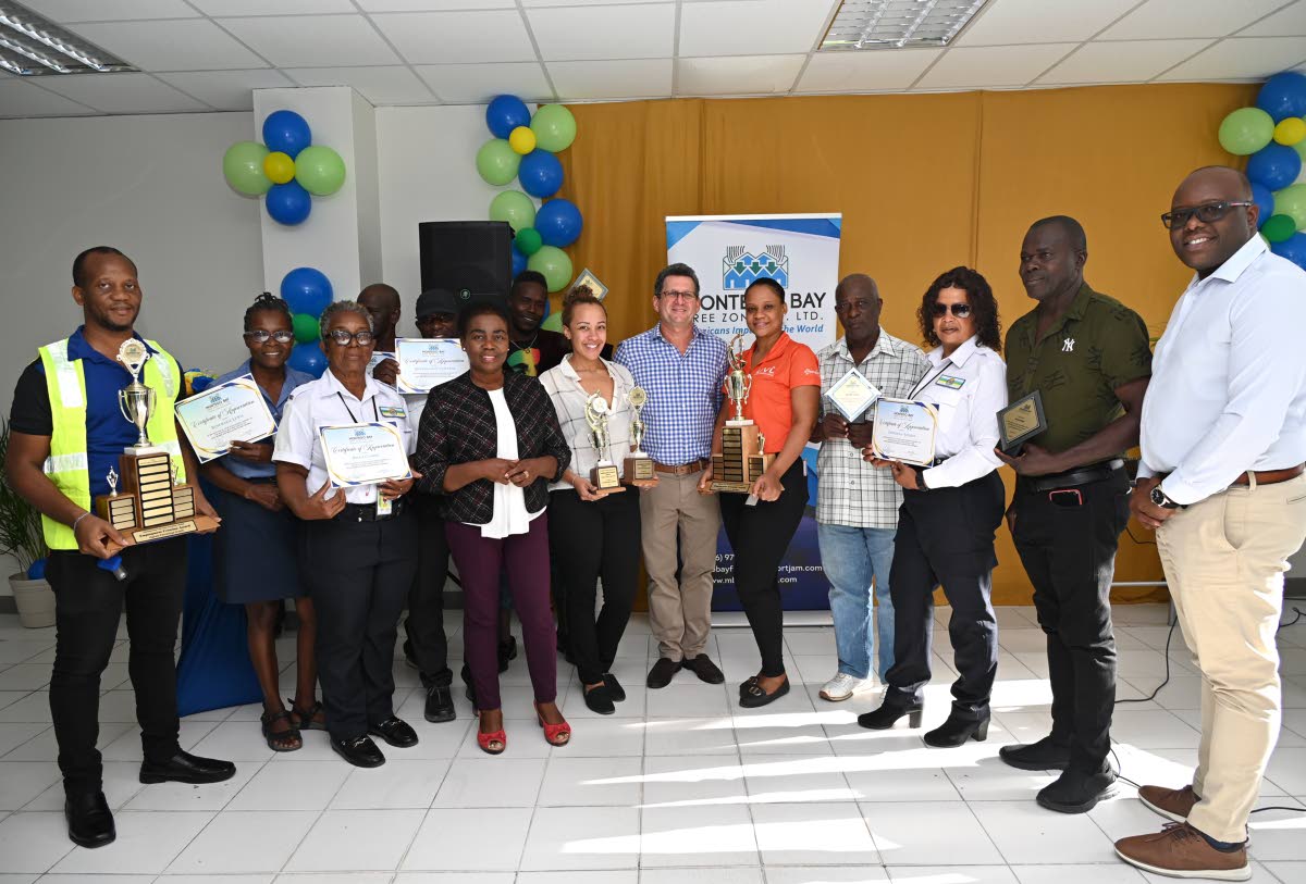 Gloria Henry (fourth left) and Mark Hart (centre) during the presentation of the Montego Bay Free Zone Employment Creation Awards at the Montego Bay Free Zone, operated by the Port Authority of Jamaica.