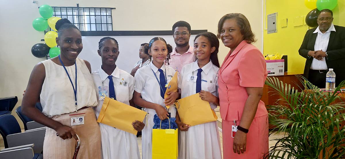 First-place winners Amia Thomas, Miaya Stewart and Zhanna Whyte of Immaculate Conception High School share a photo with their teacher, Danielle Francis (left), and Professor Marcia Roye (right), associate dean for Graduate Studies and Research in the Facul