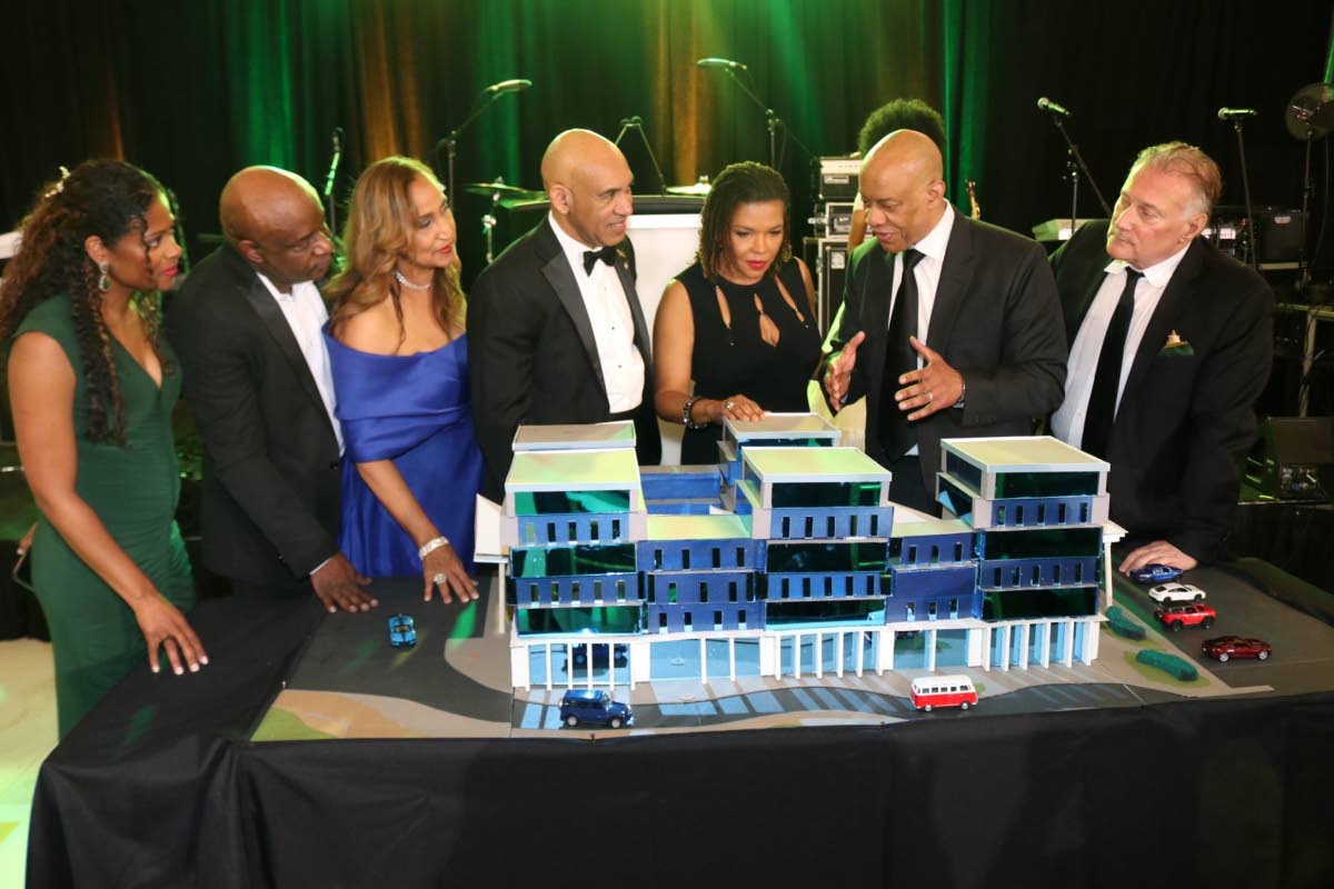 Jamaica’s Ambassador to the United States, Major General (Ret’d) Antony Anderson (centre); and Audrey Marks ((third from right), minister of efficiency, innovation and digital transformation, listen attentively as architect Christopher Carter explains 
