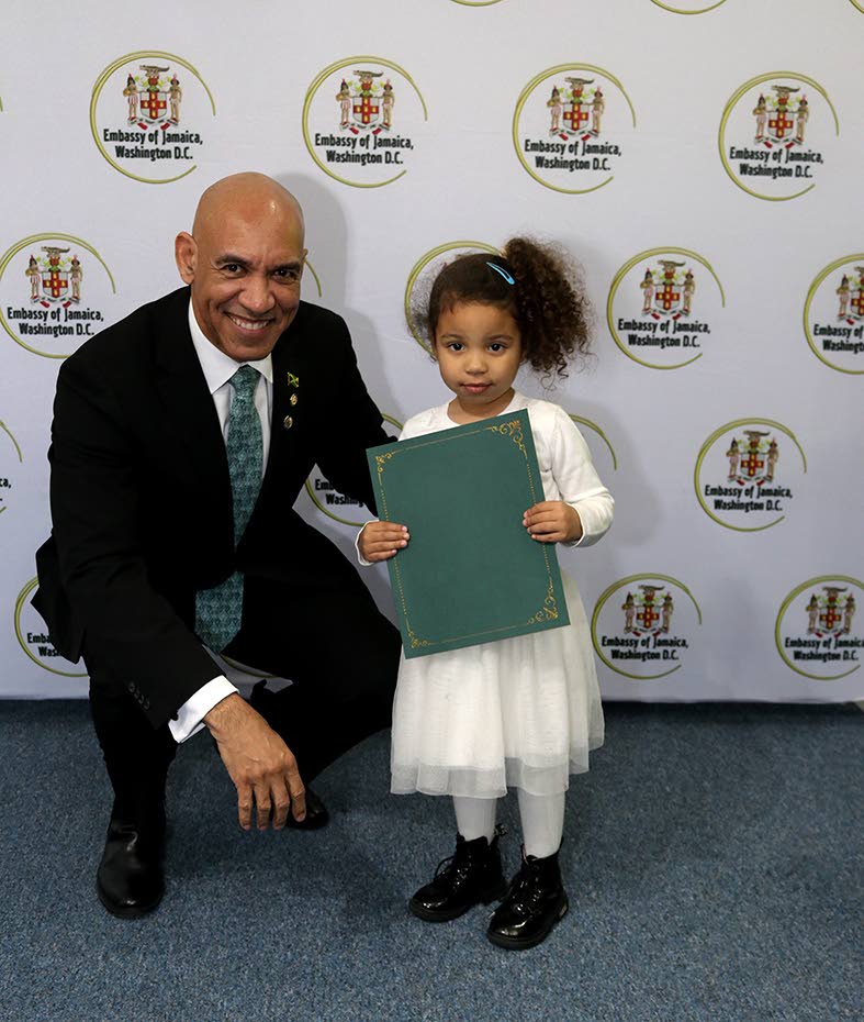  Jamaica’s Ambassador to the United States, Major General (Ret’d) Antony Anderson presents four-year-old Corey Webber Cummings, Jamaica’s newest citizen with an official letter of recognition   marking her formal entry into Jamaican citizenship.