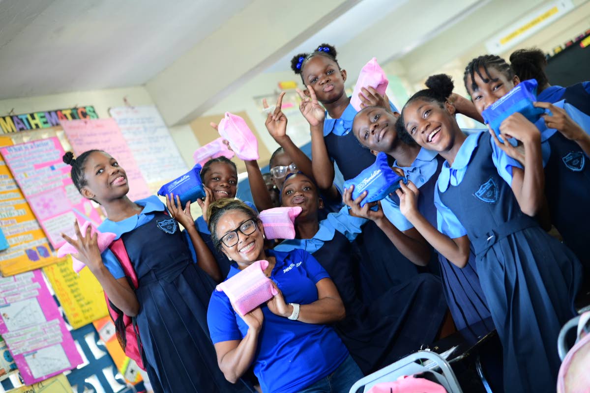 Samara South, a member of the JWN Foundation, takes some time to share in this picture moment with girls from Balmagie Primary School.