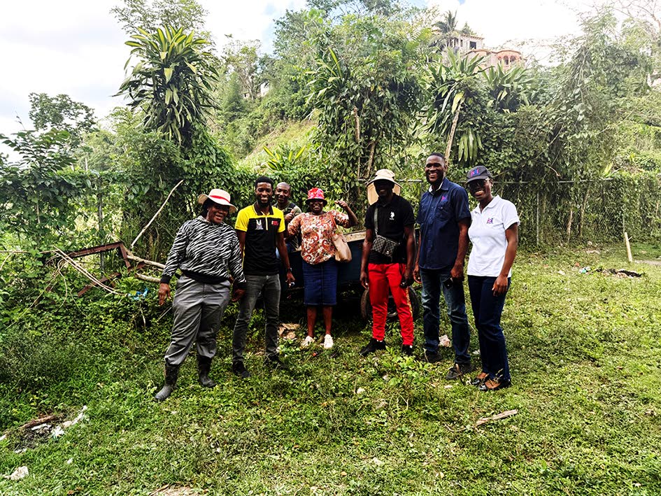 Farmers in Frankfield, Clarendon, share a photo with representatives of the Jamaica Social Investment Fund and the Rural Agricultural Development Authority in February after a stakeholder meeting.