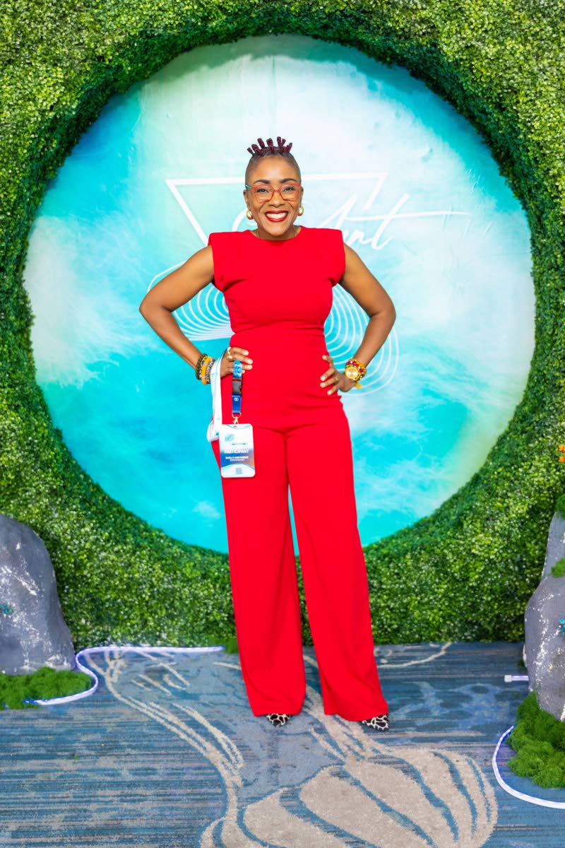 Shelly-Ann Weeks, author and activist, brings a vibrant energy in a striking red ensemble.