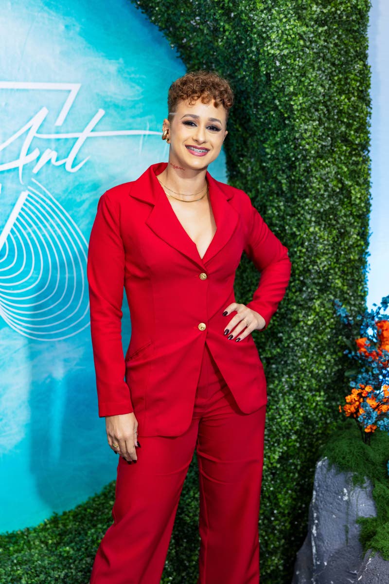 Simone Raquel Williams, CEO and director of SimoneRaquelArt Ltd, arrives at the Art of Events in a bold red tailored suit with gold accents.