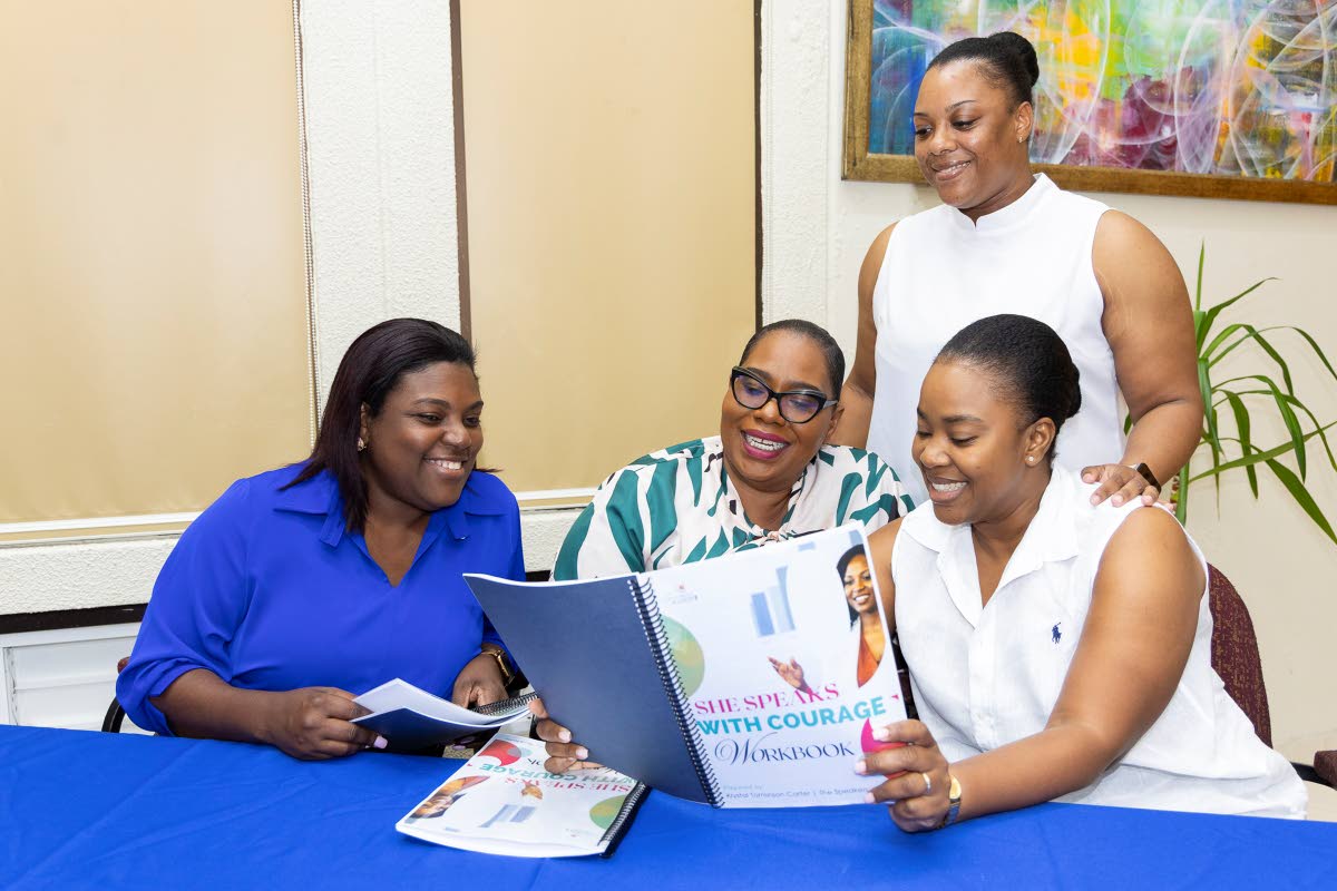 Team members from Flow Jamaica engage with the workshop material. Sudean Brown, client relations executive, stands behind her colleagues (from left) Donna Allison, sales manager, retail stores; Javana Francis, sales manager, residential sales; and Chevanic