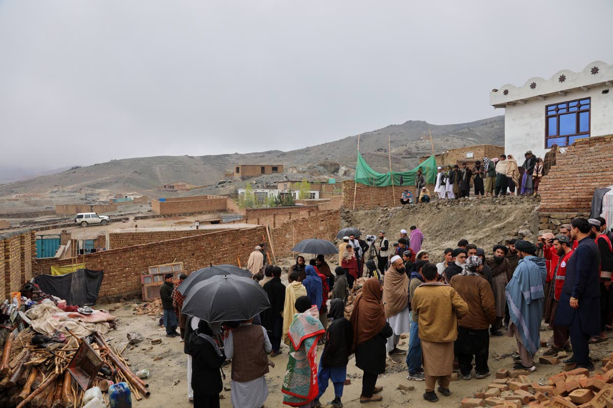 Locals and journalists inspect a house damaged by an earthquake in the village of Ittefaq, on the outskirts of Kabul, Afghanistan, Saturday, April 4, 2026. (AP Photo/Siddiqullah Alizai)