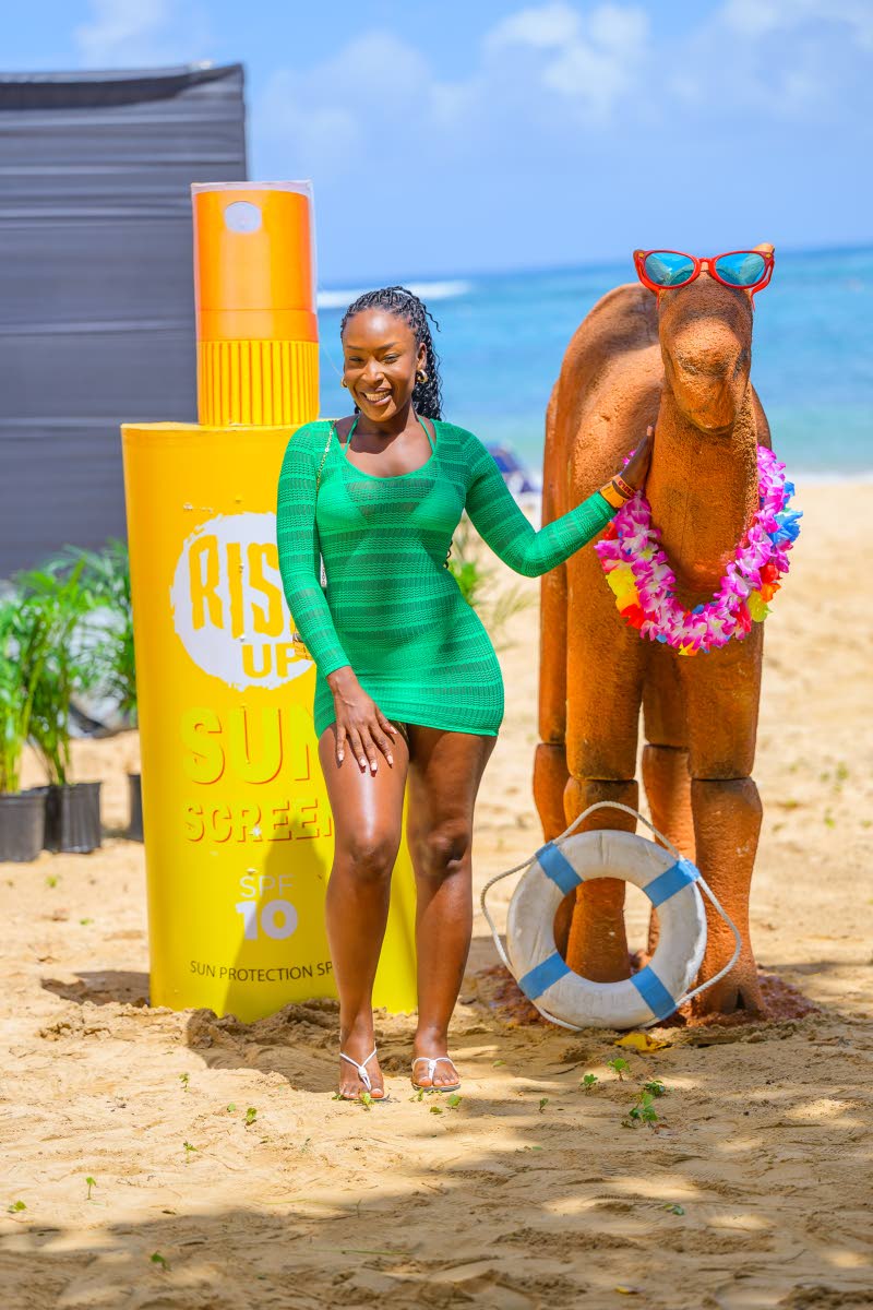 Entrepreneur Segaine Reid stands out in green beach-chic attire.