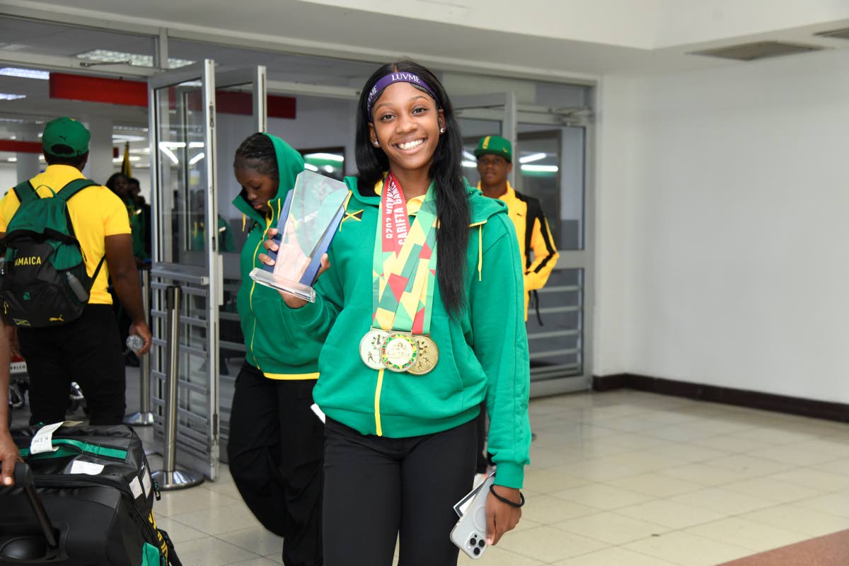 Holland High School’s Shanoya Douglas arrivees at the Norman Manley International Airport yesterday after her Austin Sealy award-winning exploits at the Carifta Games in Grenada on the weekend.