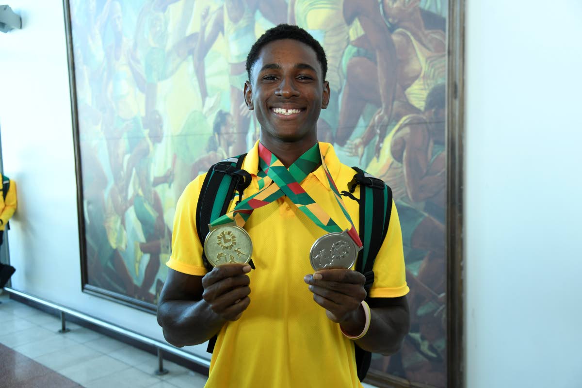 Sanay Seymore displays the two gold medals he won in the Boys’ Under-20 200 metres and the Boys’ Under-20 4x100m relays at the Carifta Games in Grenada on the weekend.