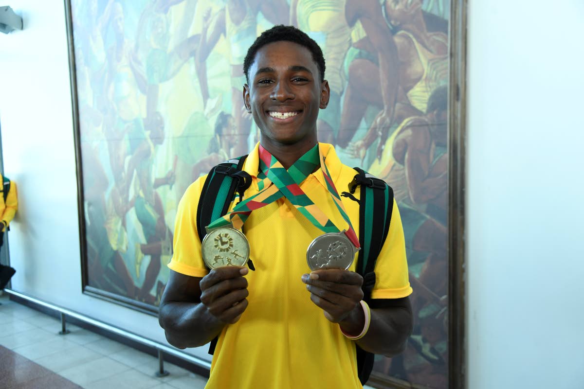 William Knibb High School’s Sanjay Seymore displays the gold medals he won in the Boys’ Under-20 200 metres and the Under-20 4x100m relays at the just-concluded Carifta Games in Grenada.
