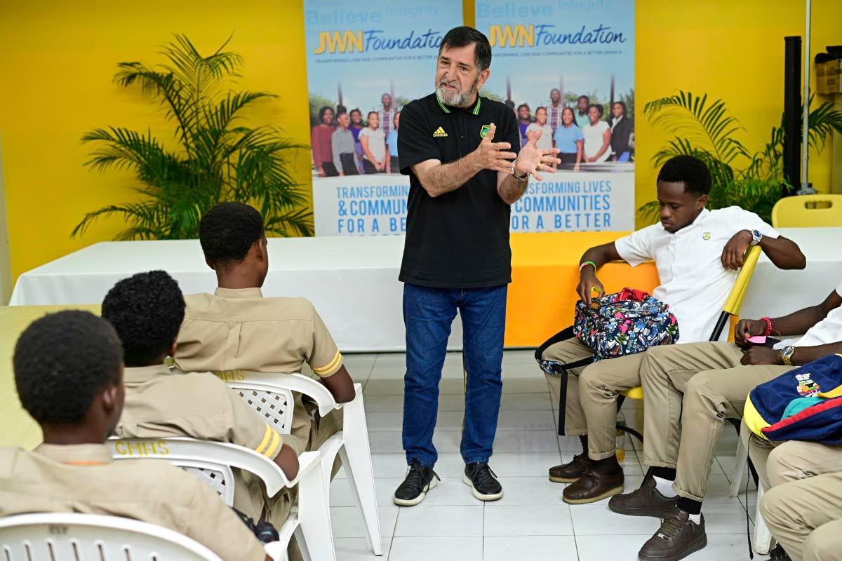 Former Reggae Boyz technical director, Rene Simoes, speaks to students of Garvey Maceo High School in Clarendon recently. 