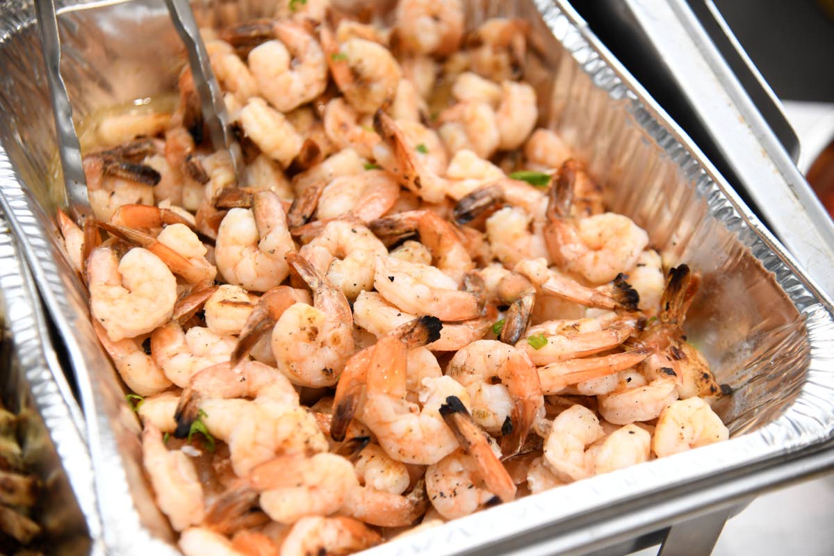 A char-grilled shrimp dish from Uncorked Jamaica, paired with pineapple salsa and spicy aioli, offers a vibrant balance of smoky seafood richness and tropical sweetness for the Le Dîner en Blanc Jamaica dining experience.