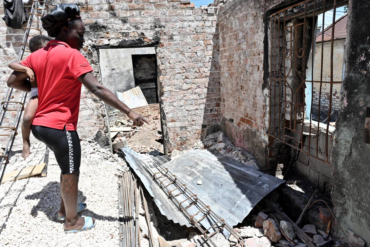 Kimonia Thomas hold her young daughter as she explains the impact of the devastating March 9 fire that left them homeless.