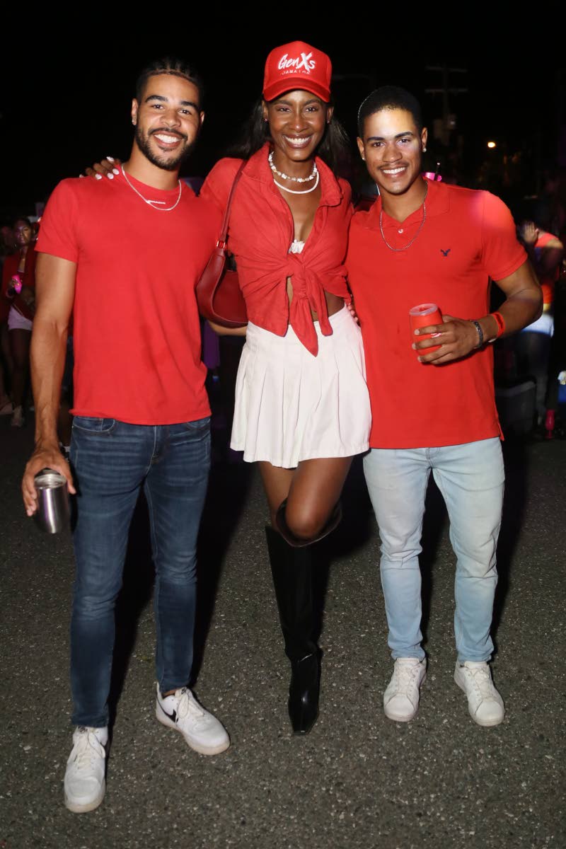 Going for a cheerleader-inspired look, model and Miss Jamaica World 2016 Ashlie Barrett is all smiles as she poses with the Nash twins, Cole (left) and Blake.