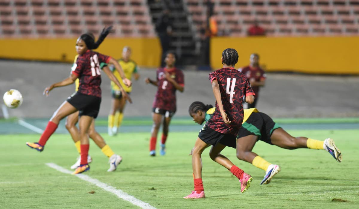 Reggae Girlz captain Khadija ‘Bunny’ Shaw (right) scores with a diving header to complete her hat-trick against Antigua and Barbuda during their Concacaf Women’s Group B qualifying match at the National Stadium last night.