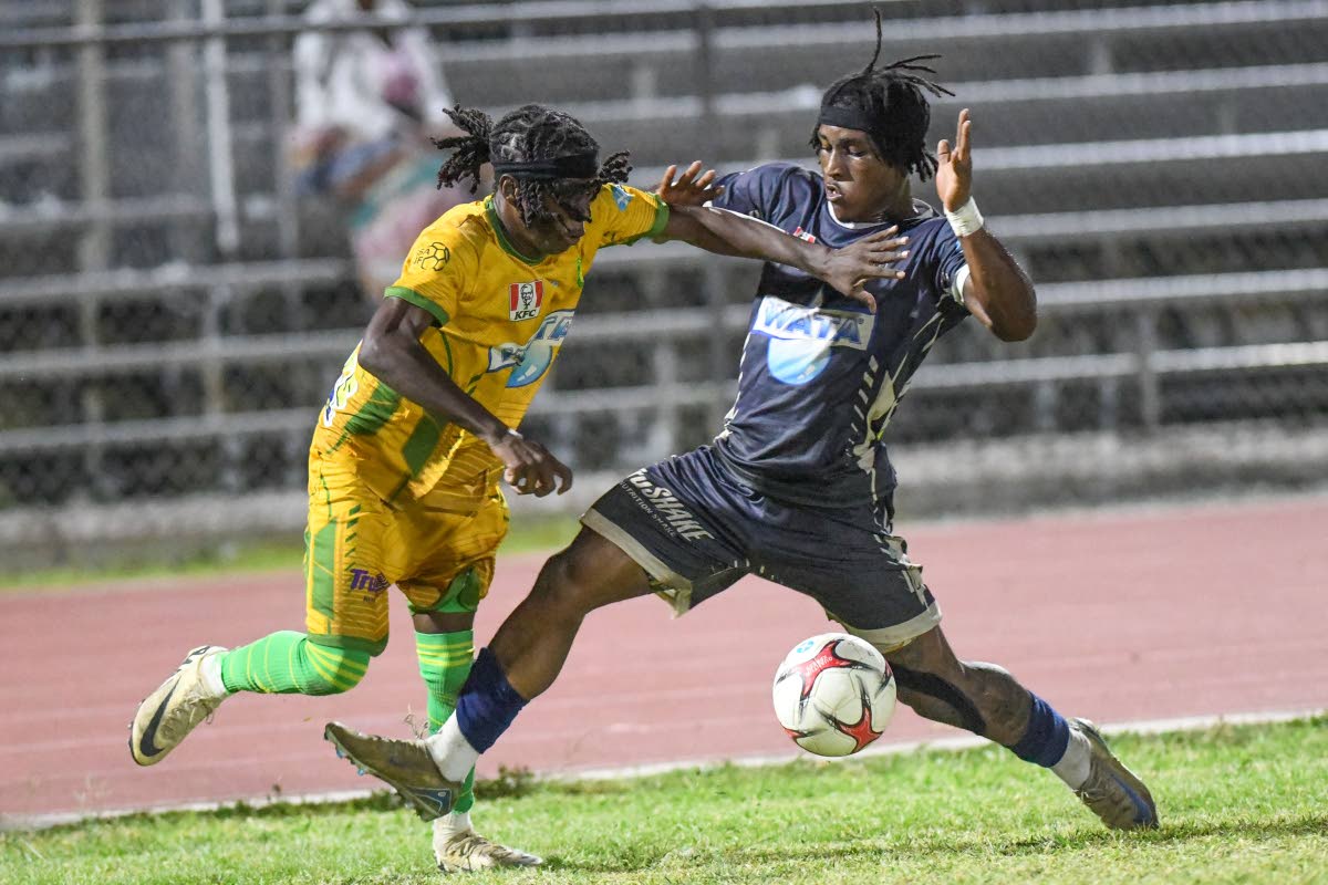 Jamoy Dennis (right) of Jamaica College tackles Tavian Byfield of St Jago High during a Manning Cup match last November.