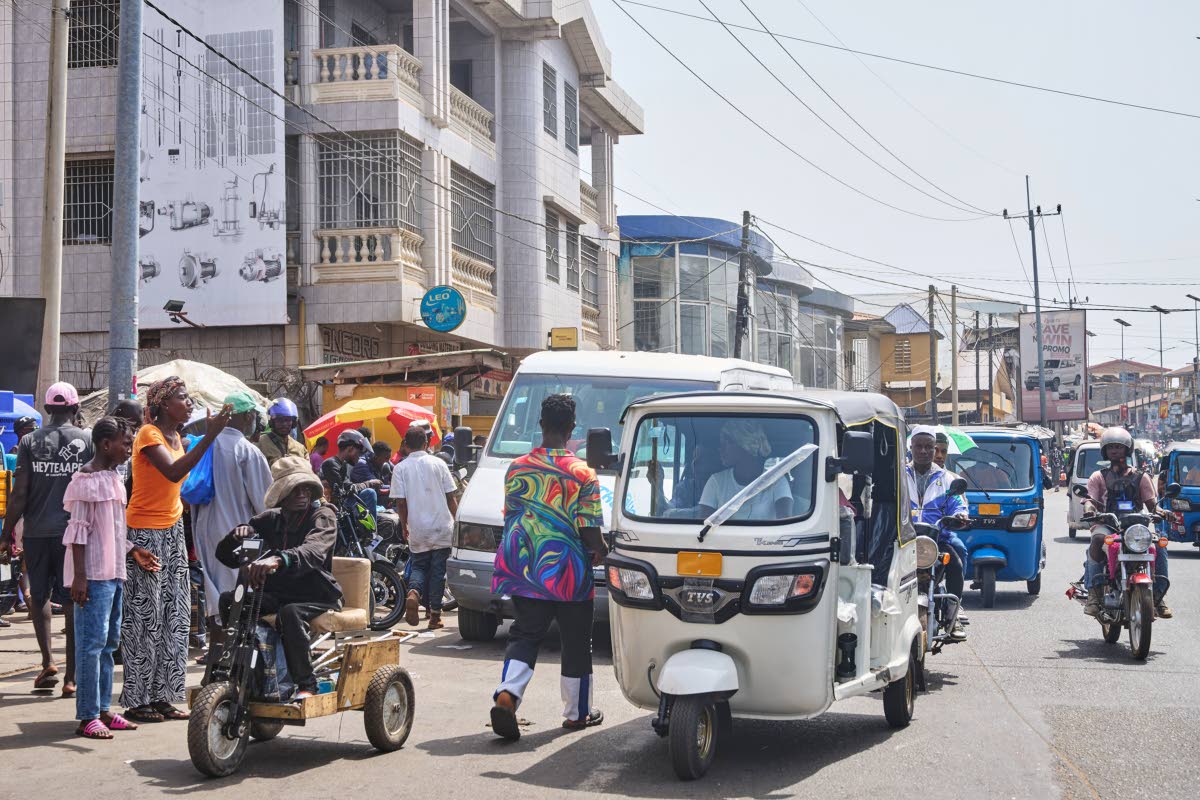 Hawa Mansaray transports a passenger in Freetown, Sierra Leone.