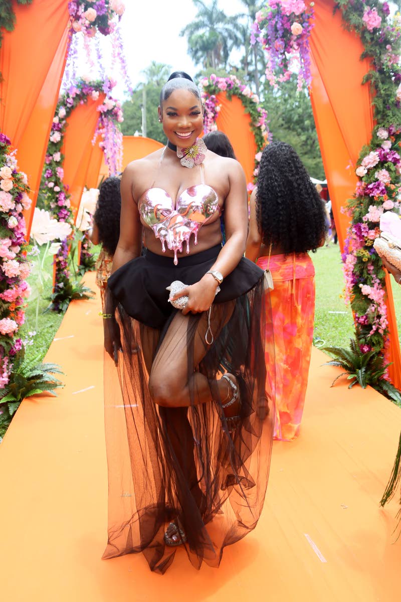 Information Systems Security Officer Chana-Lee Scott steps into frame with confidence, pairing a sculpted embellished bodice with a sheer skirt.