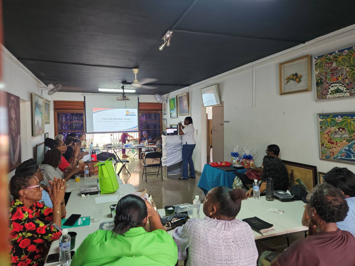 Dorraine Panton, chief pharmacist and manager at Joong Pharmacy, demonstrates the ScripTalk talking prescription system to caregivers during the Golden Designs Caregivers Masterclass: Dementia and Mental Wellness, held recently at Regardless (The Manley Ce