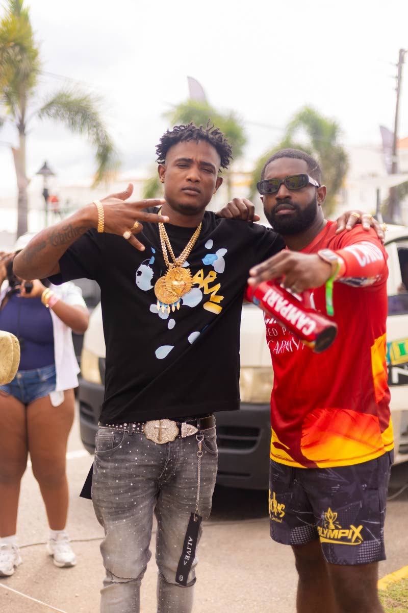 Trinidadian soca star Yung Bredda (left) poses with Jerome Walters, brand manager, Campari.