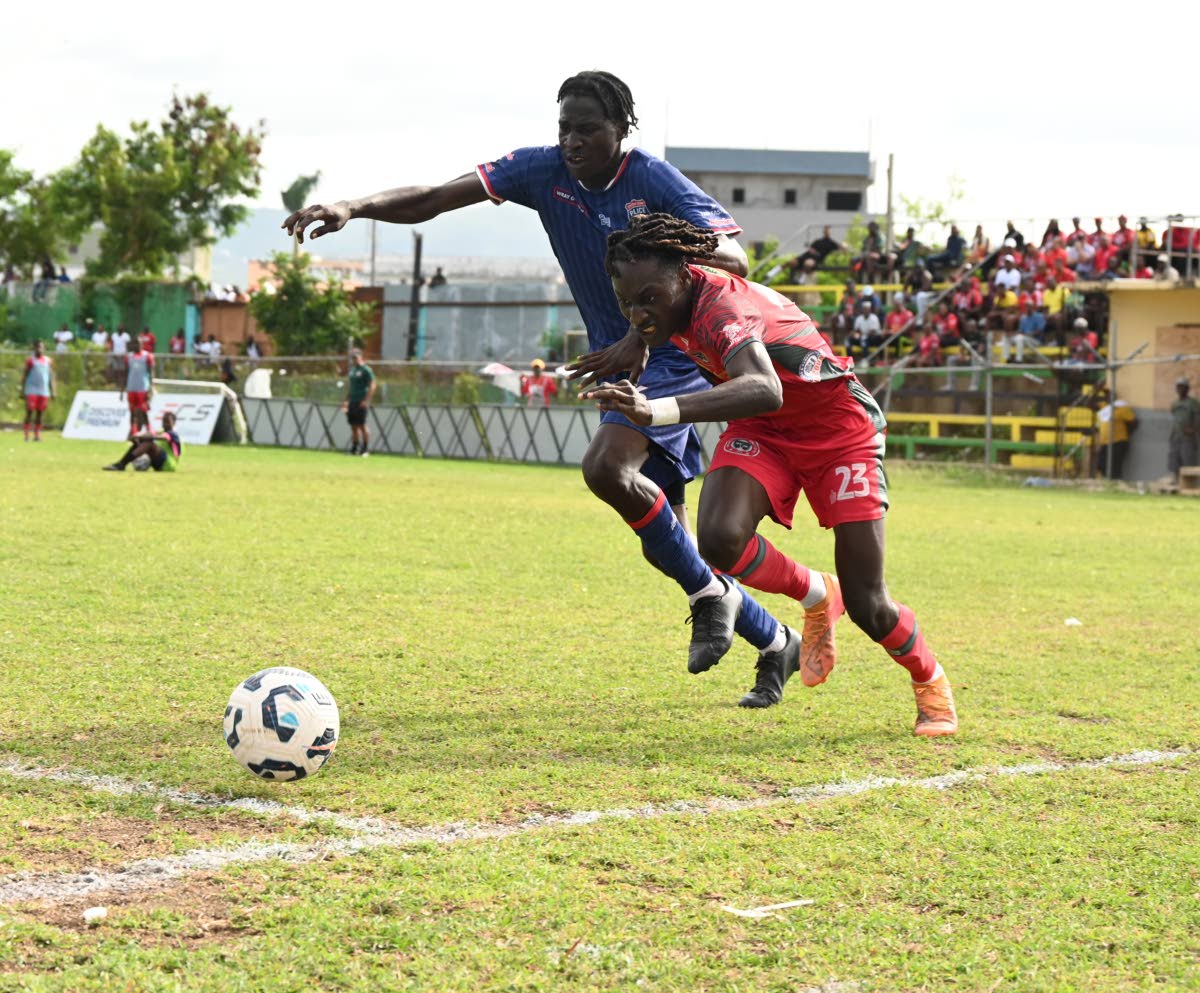 Montego Bay United’s Deonjay Brown (right) tries to dribble around Spanish Town Police’s Tajay Harris (left) during their Jamaica Premier League game at Jarrett Park in Montego Bay on Sunday.